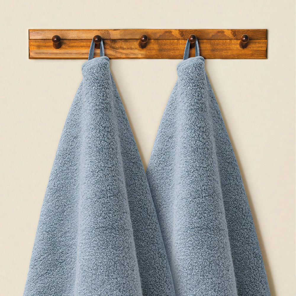 Blue Alusa Home Bamboo Collection towels hanging from their built-in loops
